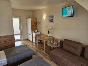 a living room with a couch and a table at Piotruś Pan in Niechorze