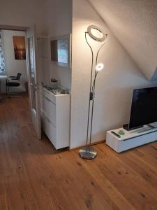 a room with a lamp on a wooden floor at Ferienwohnung Sonnenschein mit Sauna und Billiard in Wachstein