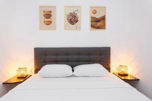 a bedroom with a large bed with two night stands at Kargı Suites Datça in Datca