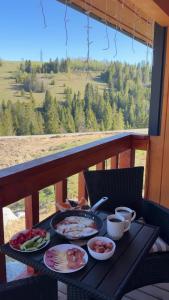 a table with plates of food on a balcony at Гимба in Podobovets
