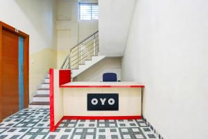 a room with stairs and a sign on a wall at Hotel O Grand Embassy in Mānglia