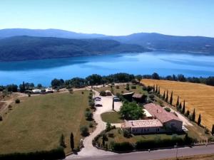 an aerial view of a house with a lake at Domaine de la Ferme Para Lou in Sainte-Croix-de-Verdon