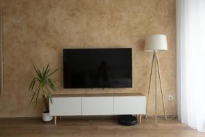 a living room with a tv on top of a white cabinet at Bitola Stay in Bitola
