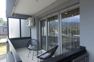 a balcony with two chairs and a table at Bitola Stay in Bitola