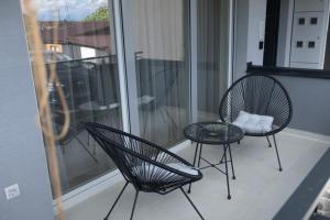 two chairs and a table on a balcony at Bitola Stay in Bitola