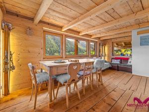 a dining room with a table and chairs in a cabin at Charmant chalet authentique de montagne Bleusy- Nendaz idéal couple et famille in Saclentse