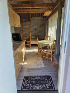 a kitchen with a sink and a table with a table at Eero Majutus in Kärdla +6 photos