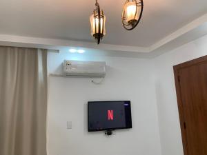 a flat screen tv on a wall in a room at رويال شقة بالتجمع الخامس امتداد الجامعة الامريكية in New cairo
