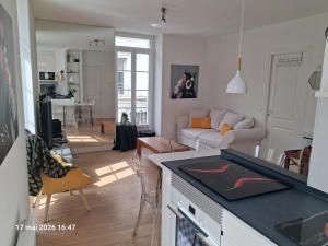 a kitchen and living room with a couch and a table at appartement centre ville in Souillac