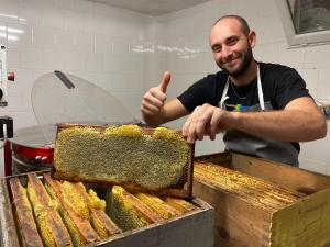a man giving a thumbs up next to a container of honey at Domaine de la Ferme Para Lou in Sainte-Croix-de-Verdon