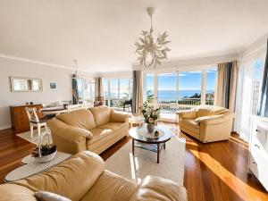 a living room with two couches and a table at Bluegreen in Arco da Calheta