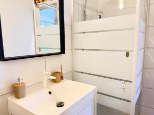 a bathroom with a sink and a mirror at Casa Buda 1BR Apartment - Lakes Malpensa MXP 24h Check-in Parking in Sesto Calende +9 photos