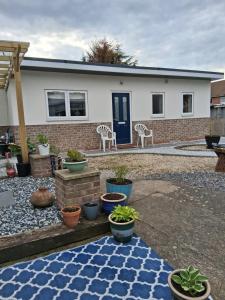 a house with potted plants in front of it at Secret Bungalow in Warsop +3 photos
