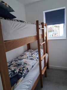 a couple of bunk beds in a room with a window at Secret Bungalow in Warsop