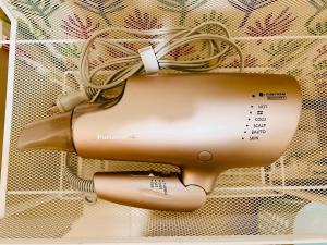 a hair dryer is hanging on a wall at チェックアウトは11時コテージそら豆ん家 in Nasu
