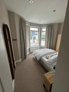 a bedroom with a bed and a window at Blackhill Lookout in Portrush