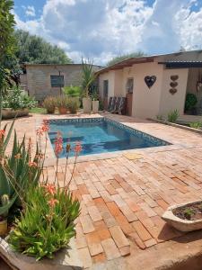 a swimming pool in a yard with plants at Orpheus Camping in Kaneb Pos