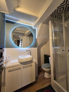 a bathroom with a sink and a mirror at Escale in Beauvais +38 photos