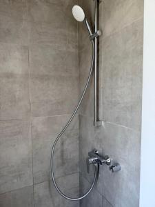 a shower with a shower head in a bathroom at LUXURY VILLA SEVEN Skiathos Town in Skiathos