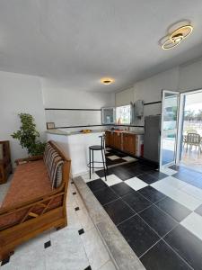 a kitchen with a couch and a table in a room at Villa Pieds dans l eau entre Lagune et Montagne in Ghār al Milḩ