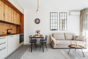 a kitchen and living room with a couch and a table at Anna Luxury BELLA VISTA in Baošići