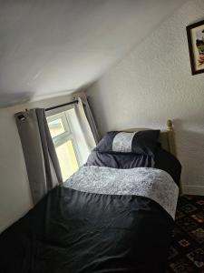 a bedroom with a bed and a window at the seaview lodge in Blackpool
