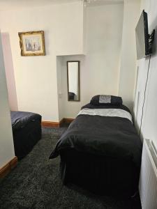 a bedroom with two beds and a mirror at the seaview lodge in Blackpool