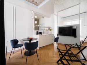 a kitchen and dining room with a table and chairs at Marszałkowska Luxury Apartments by Sofija in Warsaw +127 photos