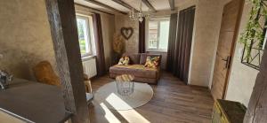 a living room with a couch and a table at Chez Denise in Eglingen