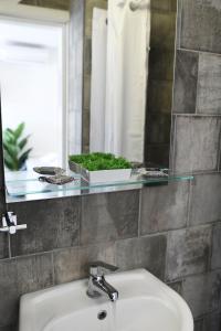 a bathroom with a sink and a mirror at Blue horizon apartment & suite in Kalymnos +31 photos
