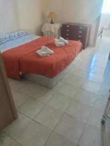 a bedroom with a bed with two towels on it at Siroco Nau Algarve in Olhão