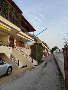 a building with a blue object on the side of it at Two-floor house next to sea in Loutraki