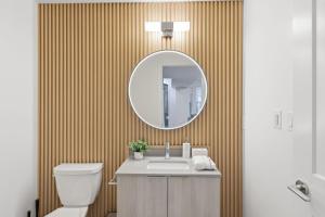a bathroom with a sink and a mirror at Widmr Residences in Toronto
