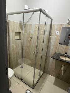 a shower in a bathroom with a toilet and a sink at Carmo Palace Hotel in Carmo do Paranaíba +15 photos