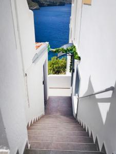 a stairway with a view of the ocean from a building at Blue horizon apartment & suite in Kalymnos
