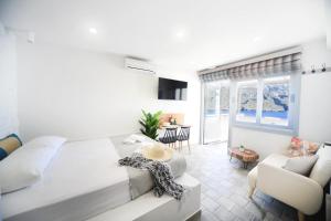 a bedroom with a bed and a living room at Blue horizon apartment & suite in Kalymnos