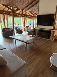 a living room with a fireplace and a flat screen tv at Do Sítio Tinoca in Atibaia