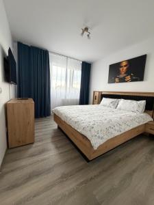 a bedroom with a bed and a television in it at marius in Chiajna