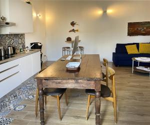 a kitchen with a wooden table with a computer on it at Antoni House in Bulzi