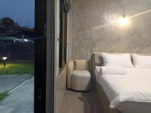 a bedroom with two beds next to a window at View Doi Resort in Ban Mai Thung Mot