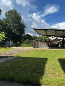 a shadow of a building on the grass at View Doi Resort in Ban Mai Thung Mot