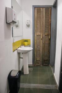 a bathroom with a white sink and a door at Soul Hostel Av Paulista Bela Vista 1 in São Paulo +36 photos