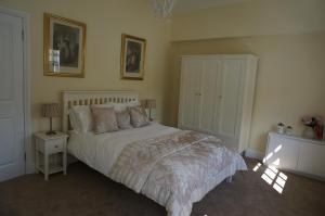 a bedroom with a bed and two lamps and a cabinet at No. 23 at The Moorings, Chester in Chester