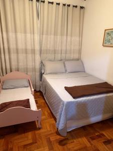 a bedroom with two beds and a window at Do Sítio Tinoca in Atibaia +28 photos