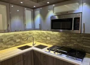 a kitchen with a sink and a microwave at Casa Luna Royale in San Juan