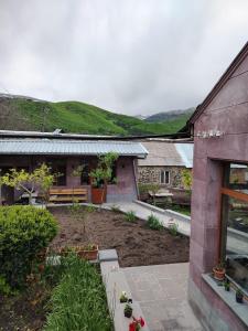 a garden in front of a building with a bench at Mashtots B&B in Vanadzor