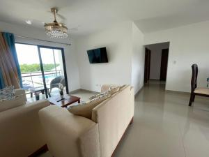 a living room with a couch and a tv at Apartment With Swimming Pool close to Beach in La Romana