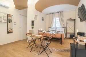 a bedroom with a bed and a table and chairs at Elite Apartment SPA in Catania +46 photos