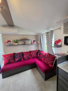 a large red couch in a living room at Les sables du midi in Valras-Plage +21 photos