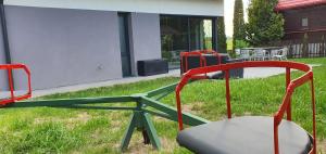 a group of chairs and a table in a yard at Dom nad Szelmentem in Przejma Wysoka +69 photos